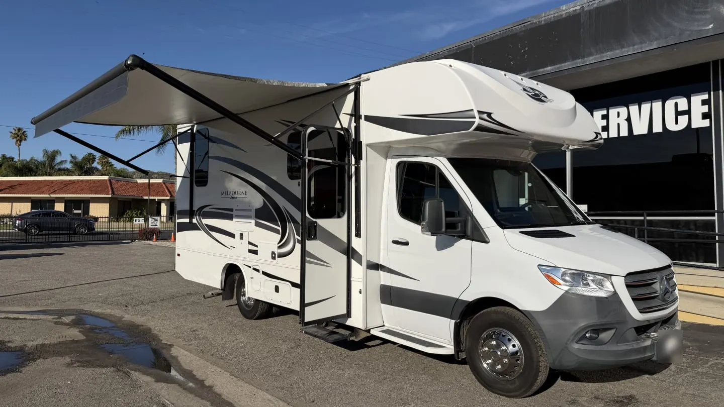 2021 Jayco Melbourne Class C motorhome with its awning out and door open