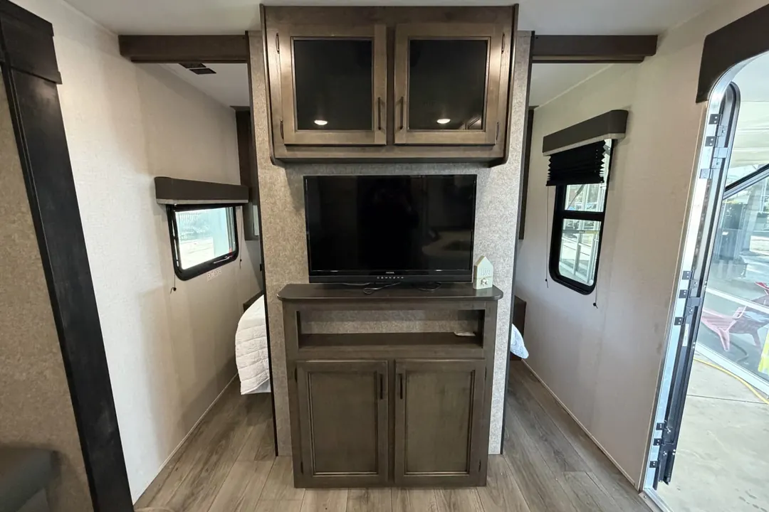 The entertainment center and cabinets inside a 2021 Highland Ridge Open Range