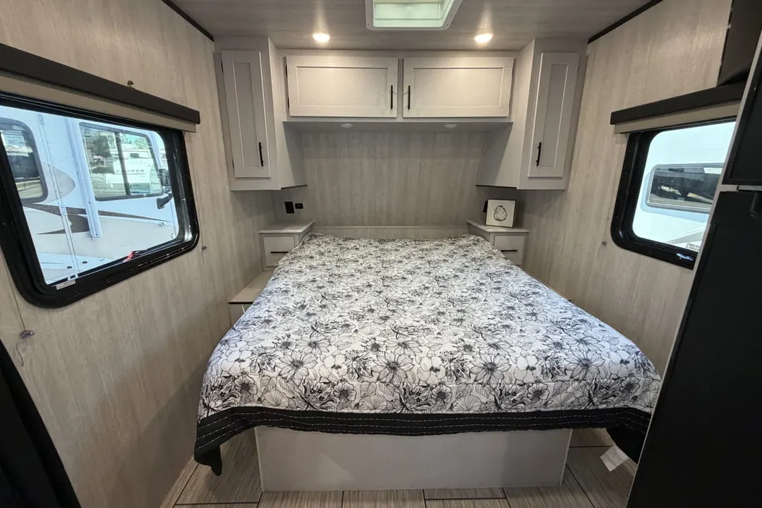 The bedroom of a 2023 Genesis Supreme Sea Breeze travel trailer