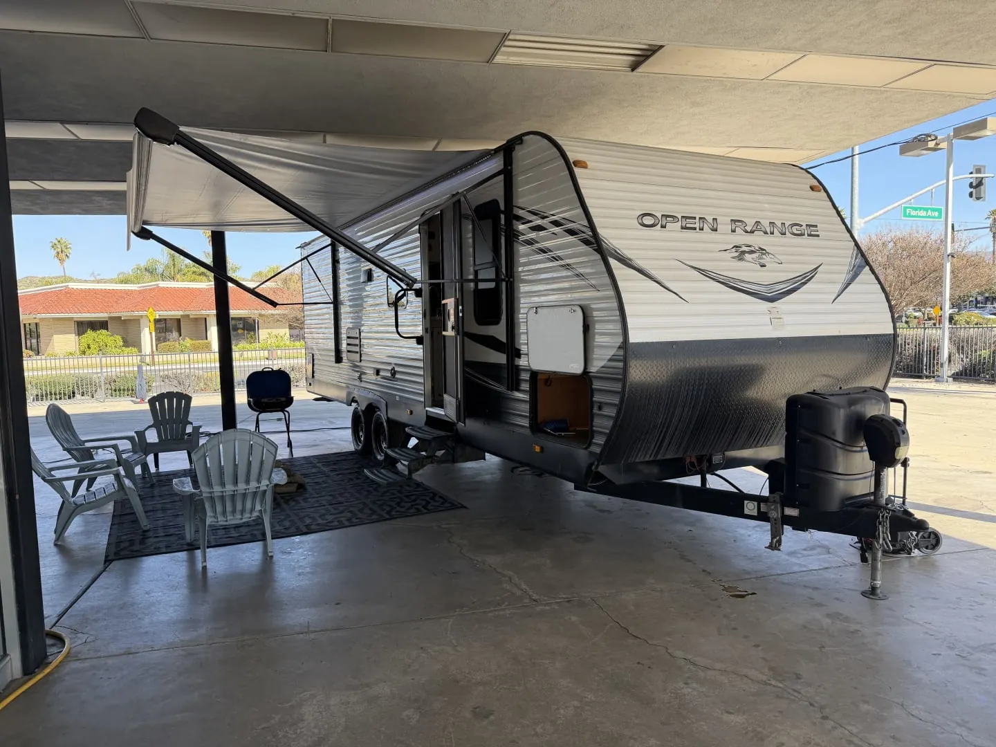 2021 Highland Ridge Open Range 26BHS travel trailer with its awning out and chairs set up